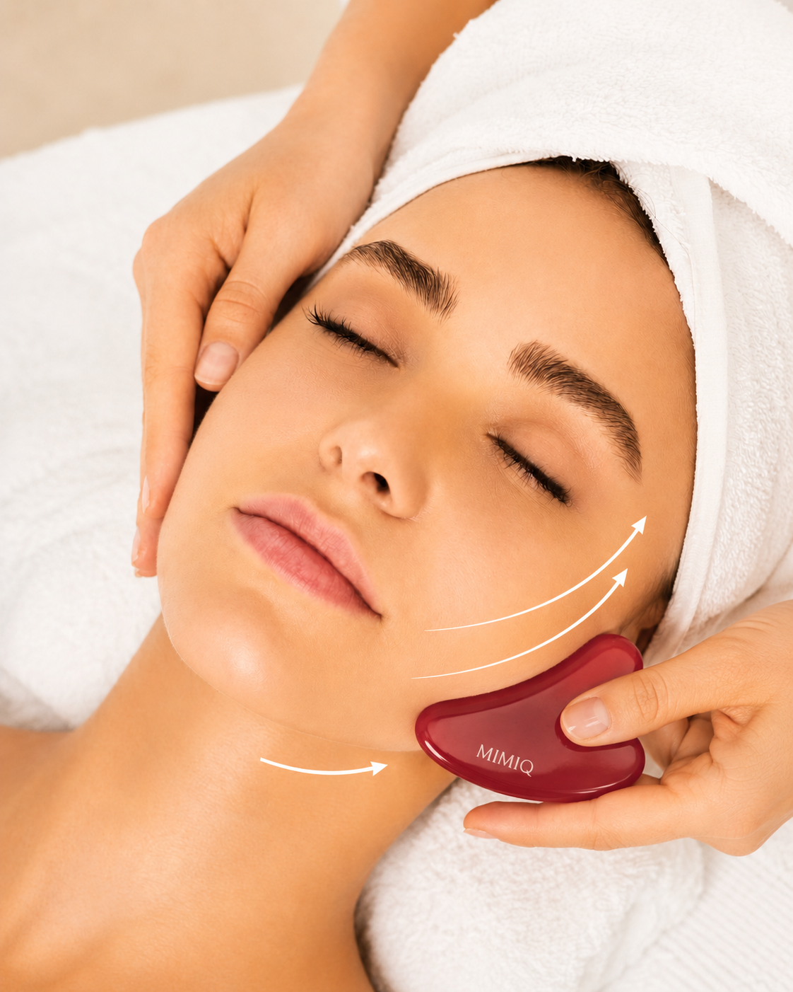 MIMIQ red gua sha used during a gentle jawline sculpting treatment
